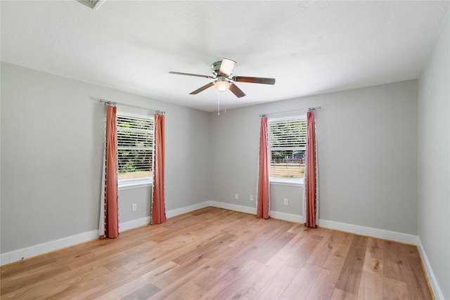 33933 Deer Creek Way, Stagecoach, TX 77355 - unfurnished room with healthy amount of natural light, a ceiling fan, and light wood finished floors