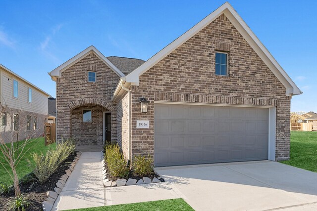 19376 Poppy Village Cir, Magnolia, TX 77355 - view of front of home with brick siding and driveway