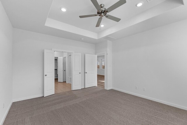 19376 Poppy Village Cir, Magnolia, TX 77355 - unfurnished bedroom with carpet, a tray ceiling, recessed lighting, and ceiling fan