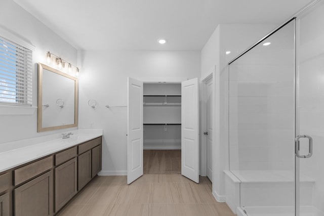 19376 Poppy Village Cir, Magnolia, TX 77355 - full bath with vanity, a shower stall, a walk in closet, recessed lighting, and tile patterned floors