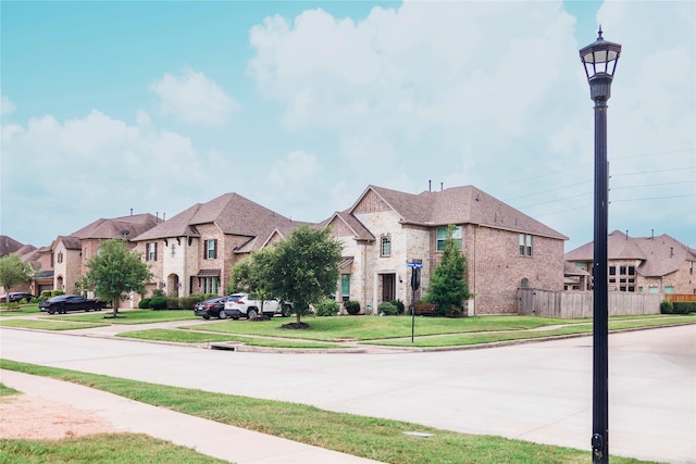 4300 Turnbridge Ct, Manvel, TX 77578 - view of concrete road with sidewalks, a residential view, street lights, and curbs