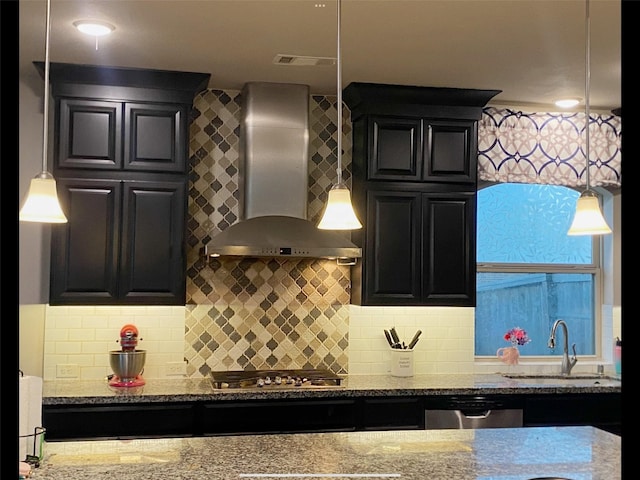 4300 Turnbridge Ct, Manvel, TX 77578 - kitchen featuring wall chimney range hood, appliances with stainless steel finishes, stone countertops, decorative backsplash, and pendant lighting