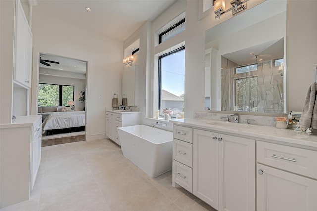 1506 W 43rd St, Houston, TX 77018 - ensuite bathroom featuring a stall shower, two vanities, a freestanding tub, tile patterned floors, and recessed lighting