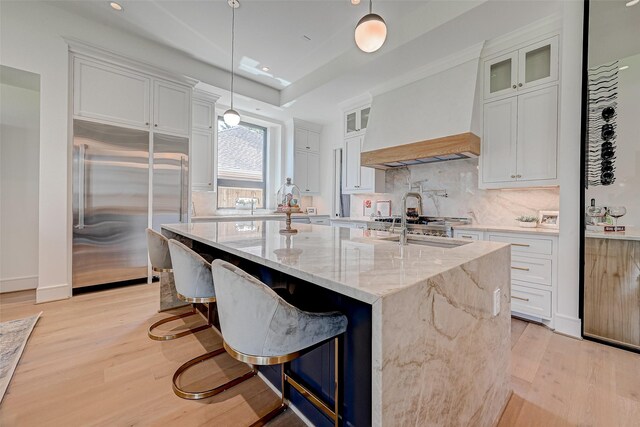 1506 W 43rd St, Houston, TX 77018 - kitchen with stainless steel built in fridge, light wood-style floors, backsplash, white cabinets, and recessed lighting