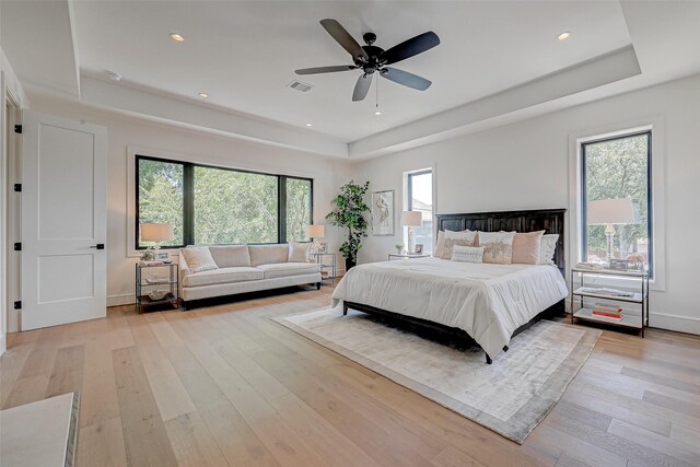 1506 W 43rd St, Houston, TX 77018 - bedroom with a tray ceiling, light wood-style flooring, a ceiling fan, and recessed lighting