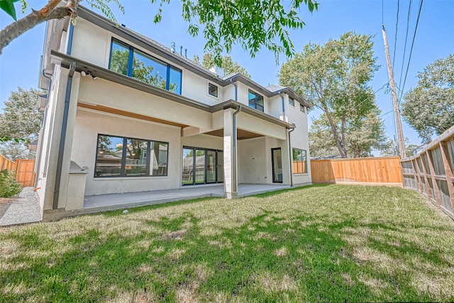 1506 W 43rd St, Houston, TX 77018 - back of property with stucco siding, a fenced backyard, and a patio area