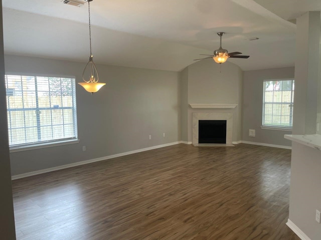 9311 Rippling Fields Dr, Houston, TX 77064 - unfurnished living room with dark wood finished floors, ceiling fan, a fireplace, and vaulted ceiling