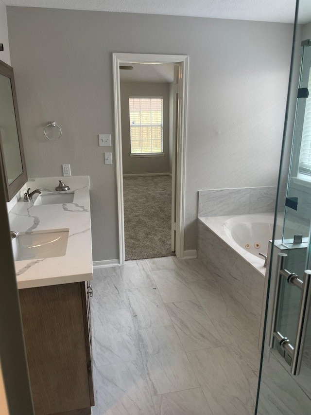 9311 Rippling Fields Dr, Houston, TX 77064 - full bath featuring double vanity, marble finish flooring, and a whirlpool tub