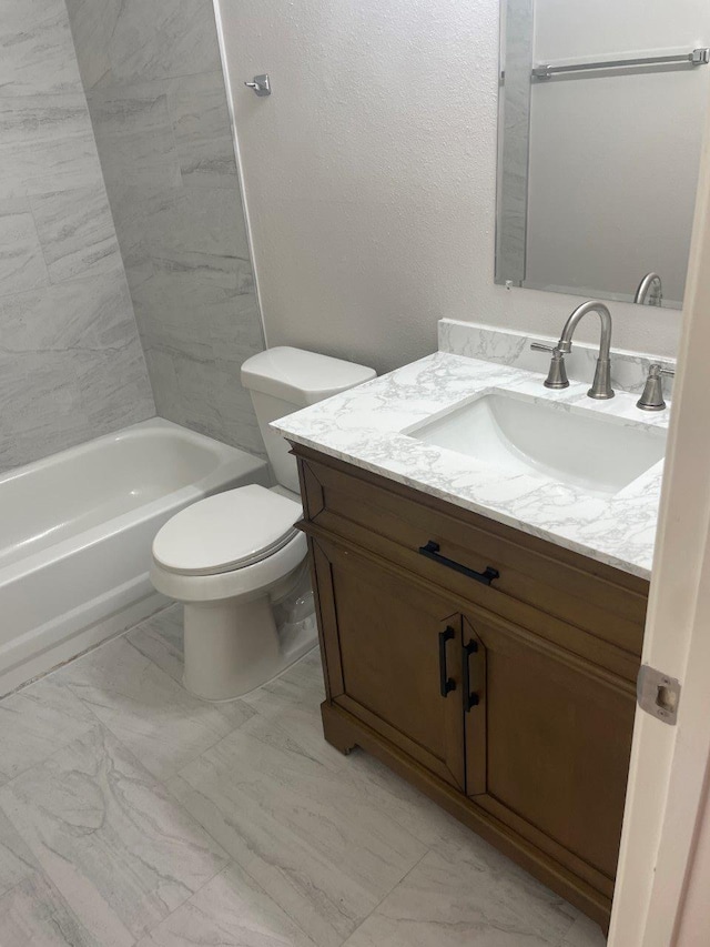 9311 Rippling Fields Dr, Houston, TX 77064 - full bathroom featuring vanity, shower / tub combination, and marble look tiles