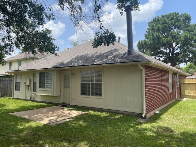 9311 Rippling Fields Dr, Houston, TX 77064 - back of property featuring roof with shingles, a patio, and brick siding