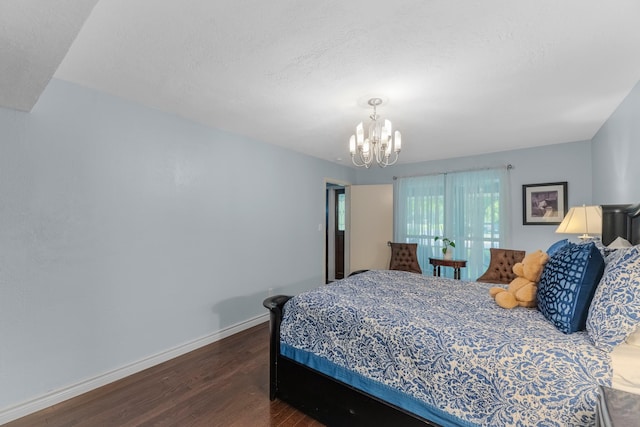 8918 James Ct, Magnolia, TX 77354 - bedroom with dark wood finished floors, a chandelier, and a textured ceiling