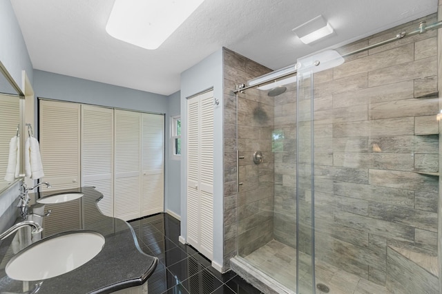 8918 James Ct, Magnolia, TX 77354 - bathroom with a closet, a stall shower, vanity, and tile patterned flooring