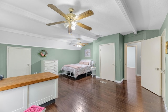 8918 James Ct, Magnolia, TX 77354 - bedroom featuring beamed ceiling, dark wood-style flooring, and a ceiling fan