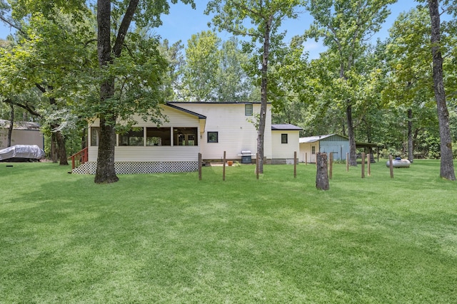 8918 James Ct, Magnolia, TX 77354 - back of property with a yard and a sunroom