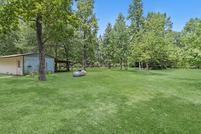 8918 James Ct, Magnolia, TX 77354 - view of green lawn with an outbuilding