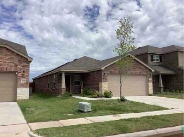 2041 Henrietta Dr, Forney, TX 75126 - view of front of house with driveway, a front yard, an attached garage, and brick siding