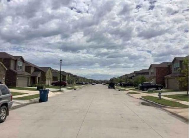 2041 Henrietta Dr, Forney, TX 75126 - view of concrete road featuring a residential view, sidewalks, street lighting, and curbs