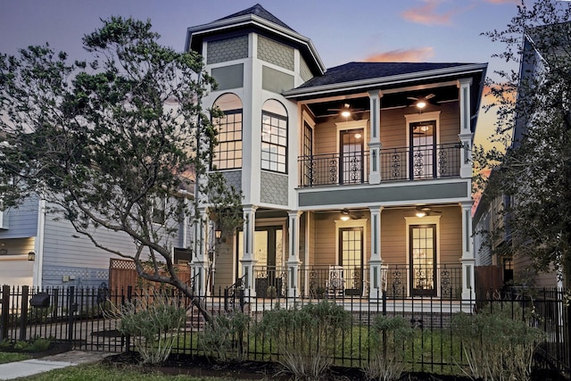 1022 W 22nd St, Houston, TX 77008 - view of front facade with a balcony, a fenced front yard, a ceiling fan, and a porch