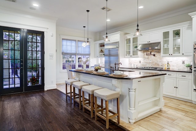 1022 W 22nd St, Houston, TX 77008 - kitchen featuring open shelves, stainless steel built in fridge, under cabinet range hood, dark countertops, and recessed lighting