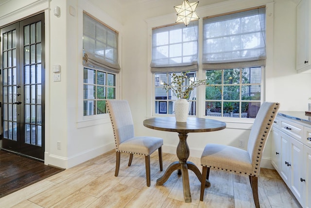 1022 W 22nd St, Houston, TX 77008 - dining room featuring french doors, wood finished floors, and a chandelier