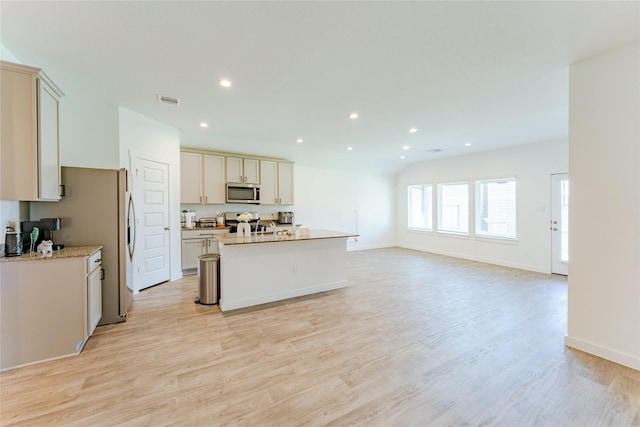 31714 Brandon Mill Trl, Fulshear, TX 77441 - kitchen featuring stainless steel microwave, stove, an island with sink, light wood-style floors, and recessed lighting