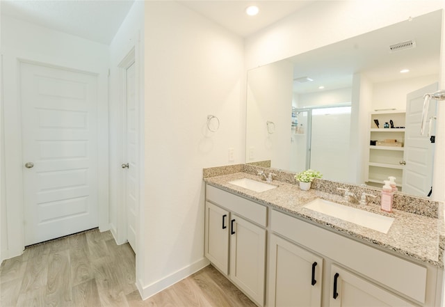 31714 Brandon Mill Trl, Fulshear, TX 77441 - full bath with wood finished floors, double vanity, a closet, and an enclosed shower