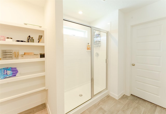 31714 Brandon Mill Trl, Fulshear, TX 77441 - bathroom with a stall shower and wood finished floors
