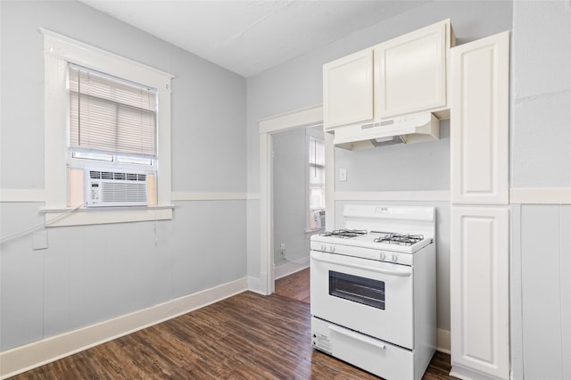 714 44th St, Galveston, TX 77550 - kitchen with white gas stove, under cabinet range hood, dark wood-type flooring, white cabinets, and cooling unit