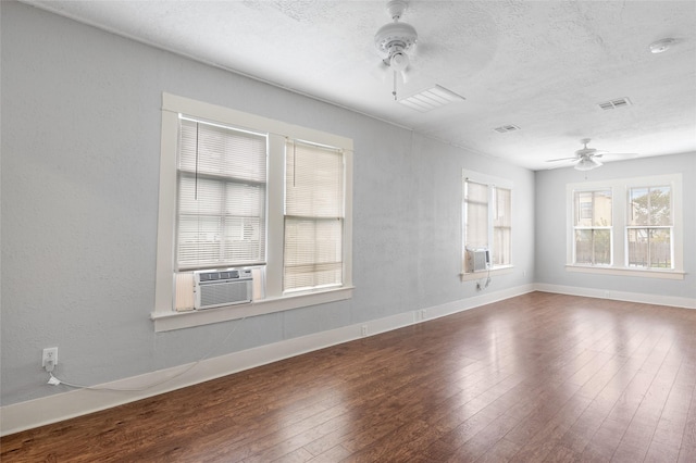 714 44th St, Galveston, TX 77550 - spare room featuring ceiling fan, wood-type flooring, a textured ceiling, cooling unit, and a smoke detector