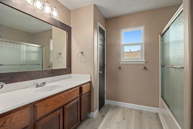 926 Seabourne Meadows Dr, Rosenberg, TX 77471 - full bathroom with wood finished floors, vanity, and bath / shower combo with glass door