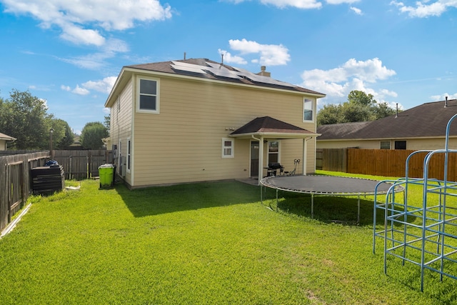 926 Seabourne Meadows Dr, Rosenberg, TX 77471 - rear view of property with a trampoline, a fenced backyard, and solar panels