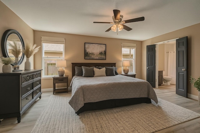 926 Seabourne Meadows Dr, Rosenberg, TX 77471 - bedroom with light wood-type flooring, ensuite bath, and ceiling fan