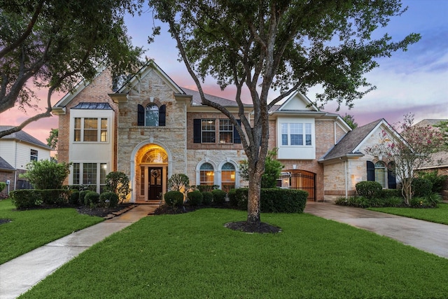 7815 Camden Hollow Ln, Humble, TX 77396 - view of front of home featuring stone siding, a front lawn, and a gate