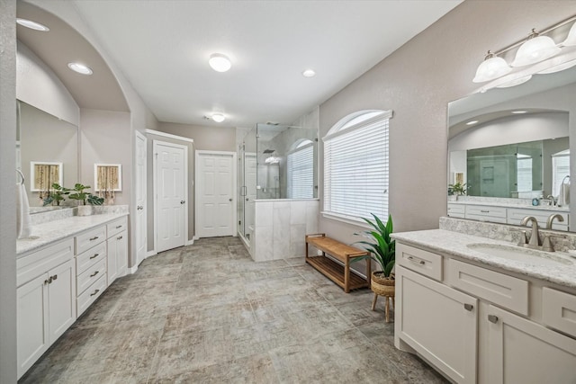 7815 Camden Hollow Ln, Humble, TX 77396 - bathroom featuring a shower stall, two vanities, and recessed lighting