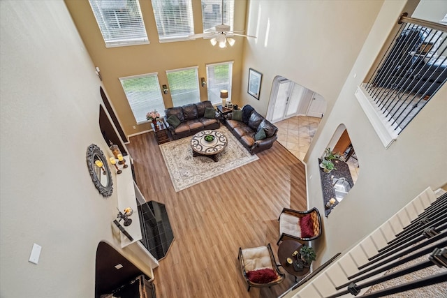 7815 Camden Hollow Ln, Humble, TX 77396 - living area featuring a high ceiling, ceiling fan, plenty of natural light, and wood finished floors