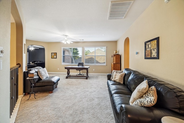 7815 Camden Hollow Ln, Humble, TX 77396 - living area featuring arched walkways, ceiling fan, and light colored carpet