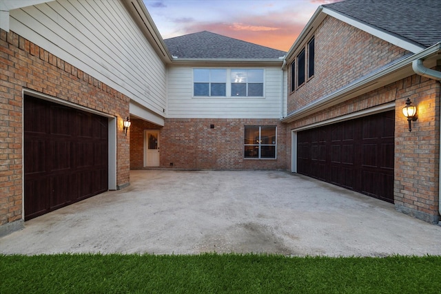 7815 Camden Hollow Ln, Humble, TX 77396 - property exterior at dusk with brick siding, roof with shingles, and driveway