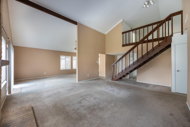 16830 Spruce Run Dr, Spring, TX 77379 - unfurnished living room featuring high vaulted ceiling, stairs, ceiling fan, and carpet