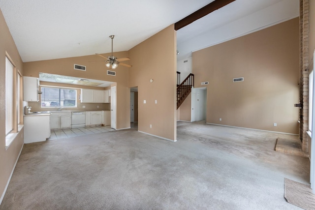 16830 Spruce Run Dr, Spring, TX 77379 - unfurnished living room with high vaulted ceiling, ceiling fan, stairway, and light carpet