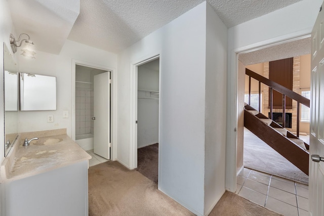 16830 Spruce Run Dr, Spring, TX 77379 - full bathroom with vanity, a textured ceiling, and a spacious closet