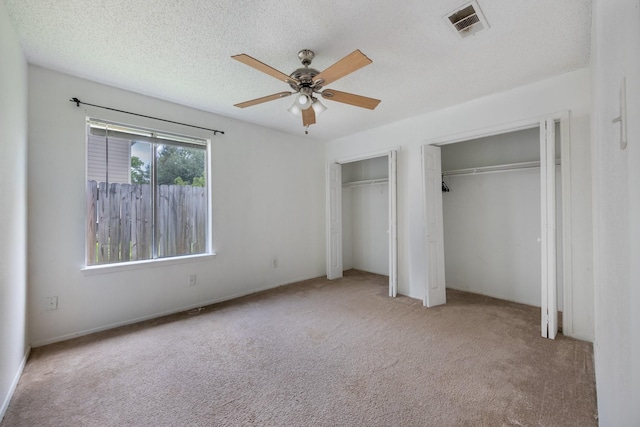 16830 Spruce Run Dr, Spring, TX 77379 - unfurnished bedroom featuring two closets, carpet floors, and a ceiling fan