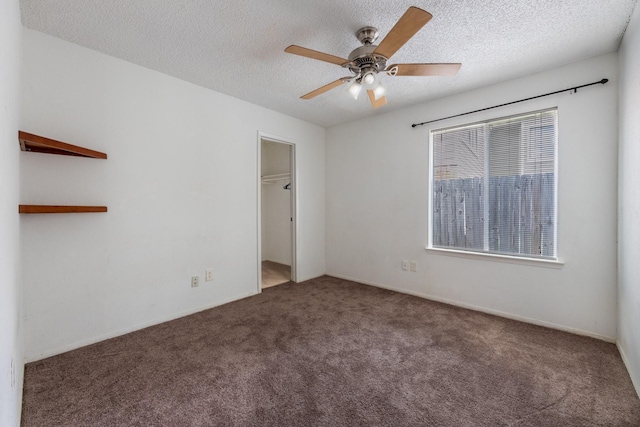 16830 Spruce Run Dr, Spring, TX 77379 - unfurnished bedroom with carpet, a textured ceiling, a walk in closet, and ceiling fan