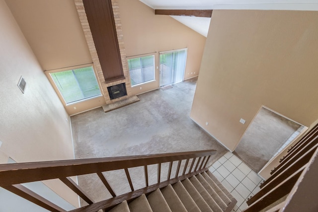 16830 Spruce Run Dr, Spring, TX 77379 - stairs with high vaulted ceiling, a fireplace, carpet floors, and tile patterned floors