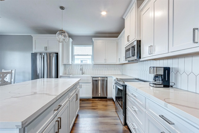 1743 Blue Water Hwy, Surfside Beach, TX 77541 - kitchen featuring appliances with stainless steel finishes, white cabinets, pendant lighting, light stone countertops, and backsplash