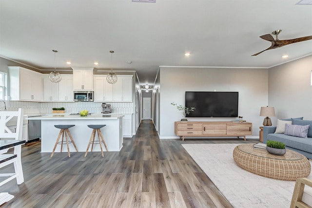 1743 Blue Water Hwy, Surfside Beach, TX 77541 - kitchen featuring stainless steel appliances, light countertops, white cabinets, a kitchen island, and open floor plan