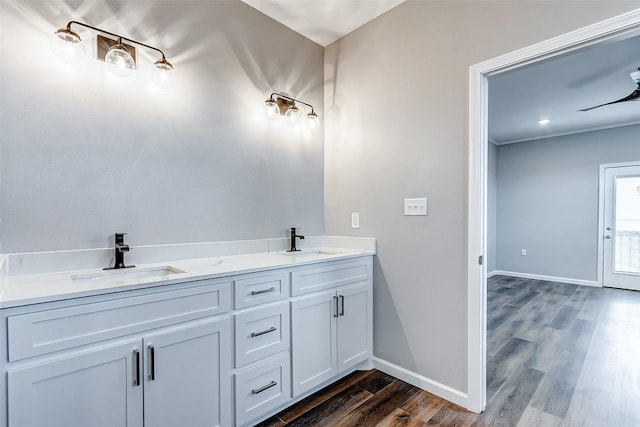 1743 Blue Water Hwy, Surfside Beach, TX 77541 - bathroom featuring wood finished floors and double vanity