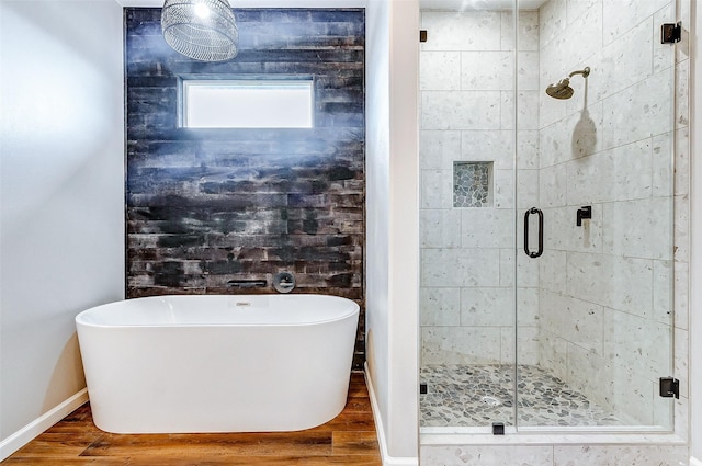 1743 Blue Water Hwy, Surfside Beach, TX 77541 - bathroom featuring a shower stall, a soaking tub, and wood finished floors