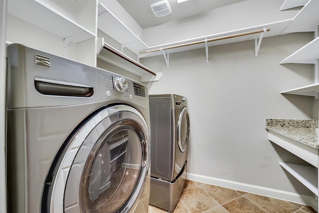 6222 Deer Run Xing, Katy, TX 77493 - laundry room with washer and dryer and light tile patterned flooring