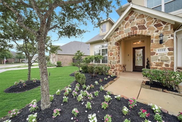 6222 Deer Run Xing, Katy, TX 77493 - doorway to property featuring stone siding and a yard