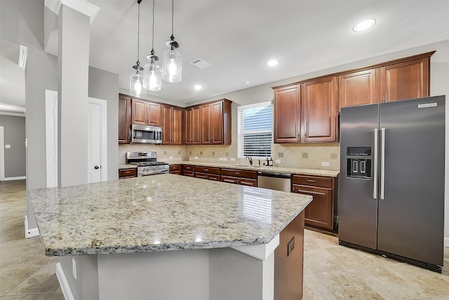 6222 Deer Run Xing, Katy, TX 77493 - kitchen with stainless steel appliances, backsplash, light stone counters, a kitchen island, and pendant lighting